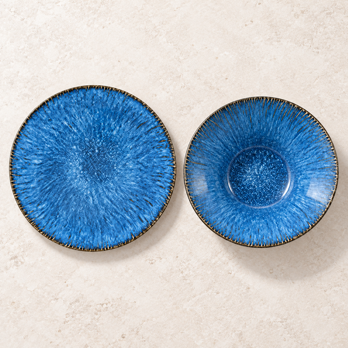 Empty kiln-blue plate and flared bowl compared from overhead