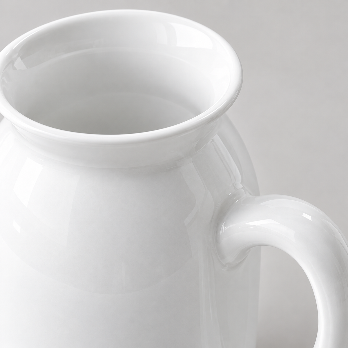 Glossy ceramic lip and handle attachment detail of the decorative vase