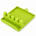 Green four-slot spoon rest on white background