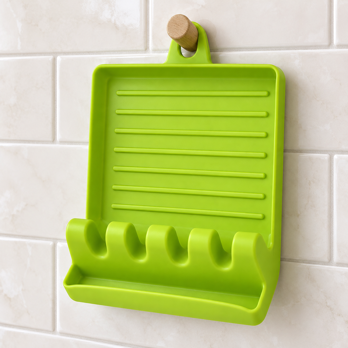 Green spoon rest hanging by its molded loop