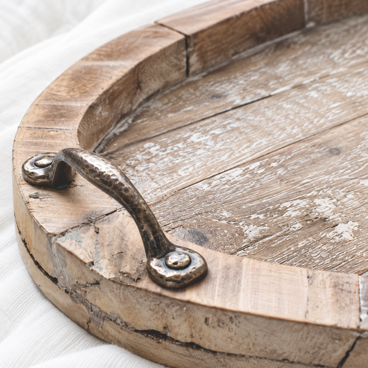 Rustic oval wooden serving tray, handle-detail view; styling accessories not included