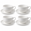 Four white ribbed ceramic cappuccino cups with four matching saucers on a white background.