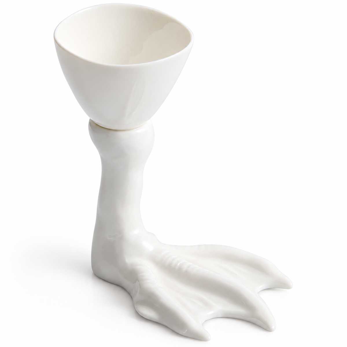 Deep white ceramic bowl on webbed goose-foot pedestal, on white