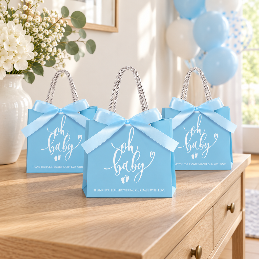 Three blue Oh Baby favor bags displayed on a baby shower console