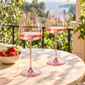 Pair of pink slanted glasses on sunny balcony
