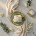 Floral ceramic coffee cup and saucer with gold spoon, overhead flat-lay place setting