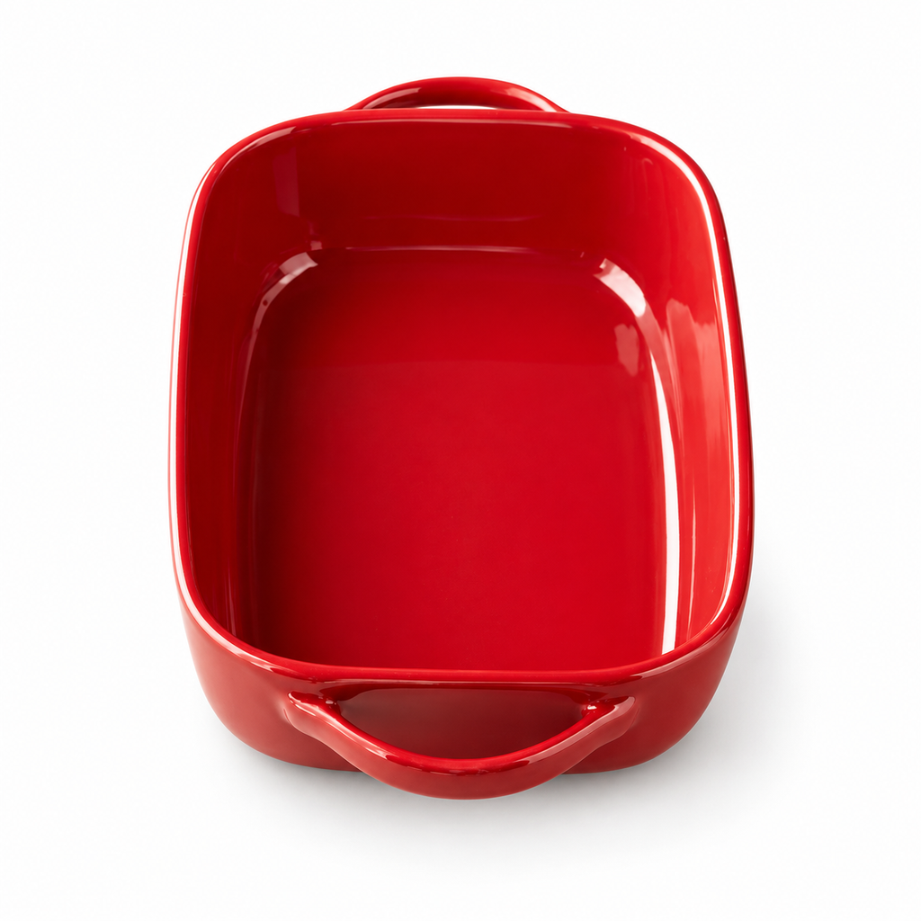 Red ceramic dish with two open loop handles on a white background