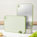 Two-tone mint-green and stainless steel cutting board with stand
