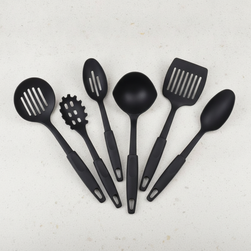 Six-piece black silicone-coated kitchen utensil set fanned out on a light counter