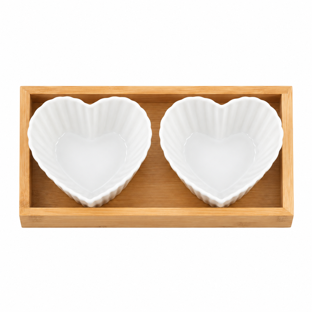 F heart-shaped fluted ceramic bowls in bamboo tray, empty overhead view