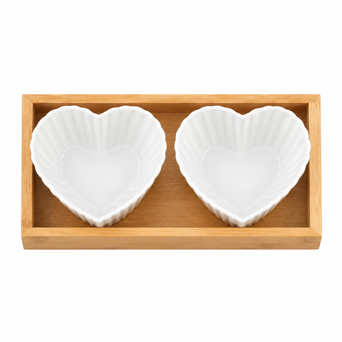 F heart-shaped fluted ceramic bowls in bamboo tray, empty overhead view