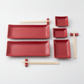 Vermiglio hand-glazed red ceramic sushi set for two, 8 pieces with serving plates, soy dishes, bamboo chopsticks and rests on white
