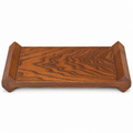 Brown wooden display riser with faceted raised ends on a white background